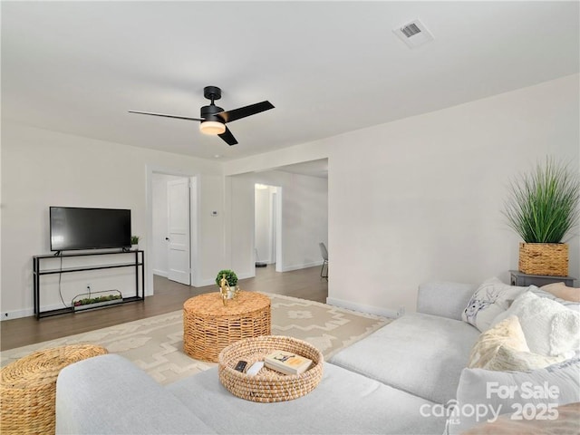 living room with wood-type flooring and ceiling fan