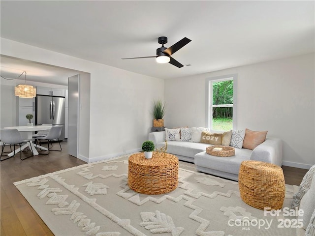 living room featuring hardwood / wood-style floors and ceiling fan