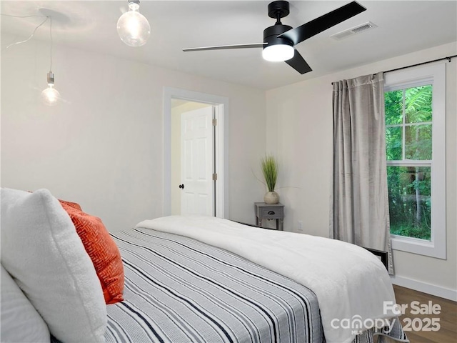 bedroom with wood-type flooring and ceiling fan