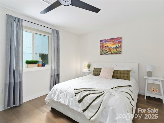 bedroom with dark hardwood / wood-style floors and ceiling fan