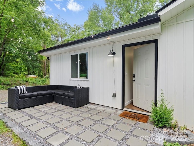 entrance to property featuring a patio and an outdoor hangout area