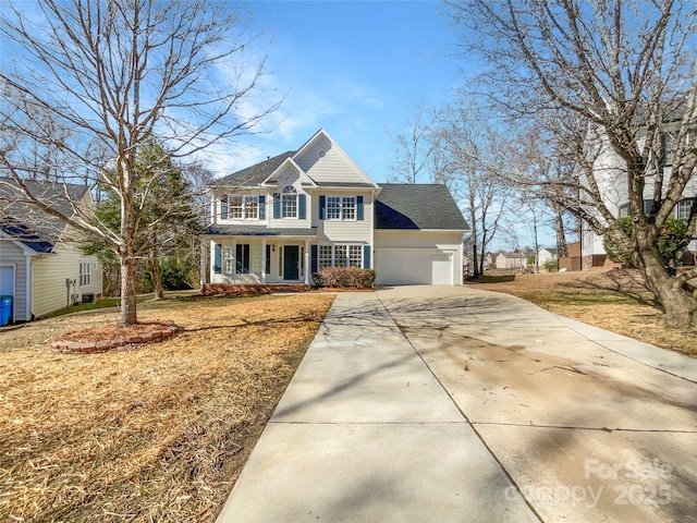 view of front of house featuring a garage, covered porch, and a front yard