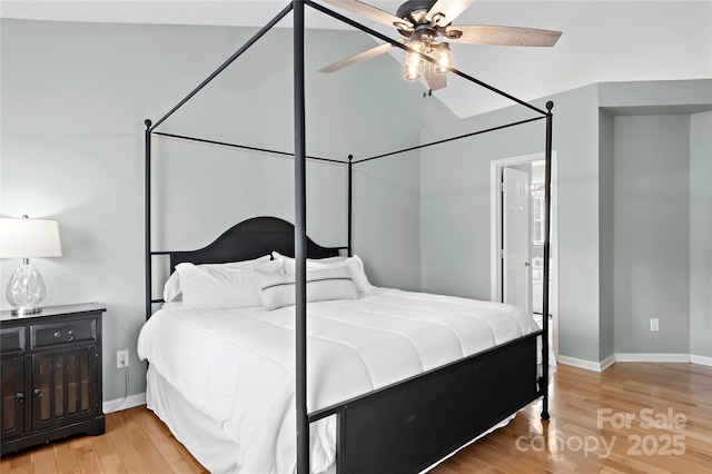 bedroom featuring ceiling fan, lofted ceiling, and light hardwood / wood-style flooring