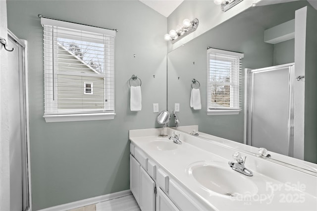 bathroom featuring a shower with door and vanity