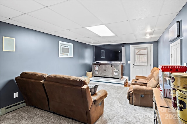 living room featuring a baseboard radiator, carpet flooring, and a drop ceiling