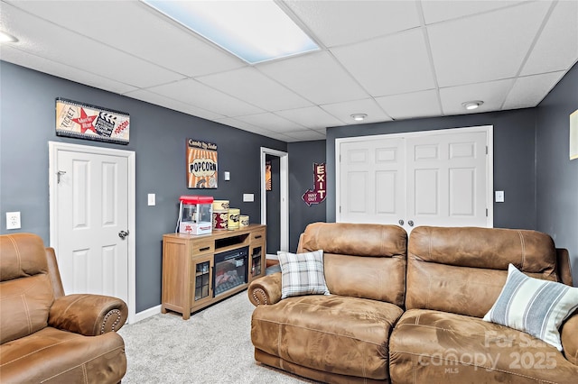 living room featuring light colored carpet and a drop ceiling