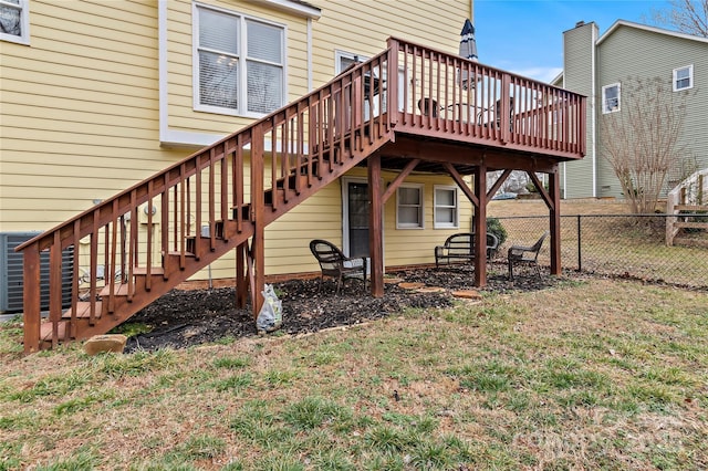 rear view of house featuring a yard and a deck