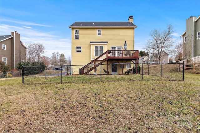 back of property with a yard and a deck