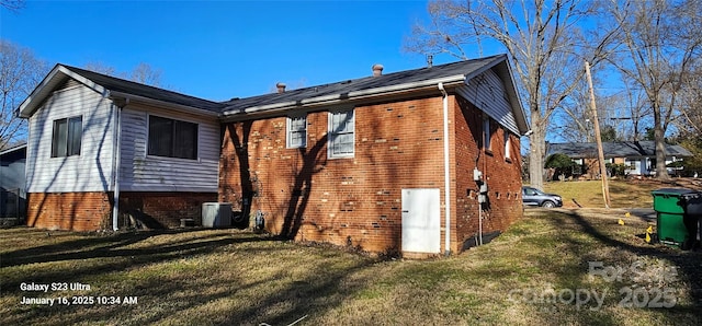 rear view of property featuring a yard