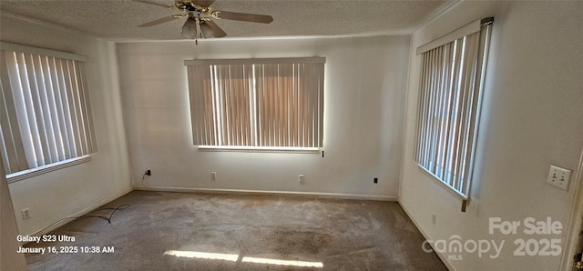 carpeted spare room featuring ceiling fan and a textured ceiling