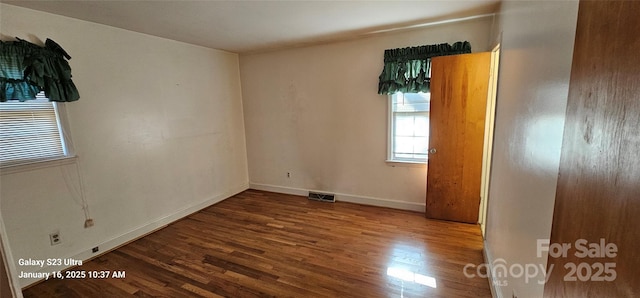 empty room with hardwood / wood-style floors