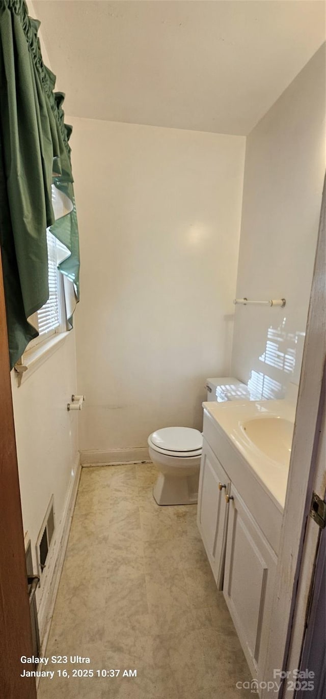 bathroom featuring vanity and toilet