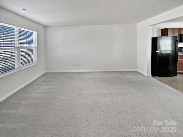 unfurnished living room with light carpet