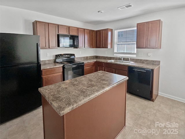 kitchen with light tile patterned floors, sink, a kitchen island, and black appliances