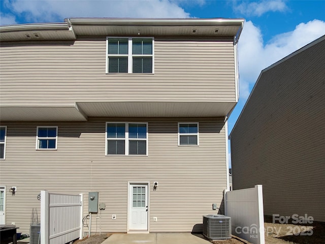 rear view of house featuring central AC unit and a patio area