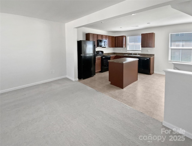 kitchen with light carpet, sink, black appliances, and a center island