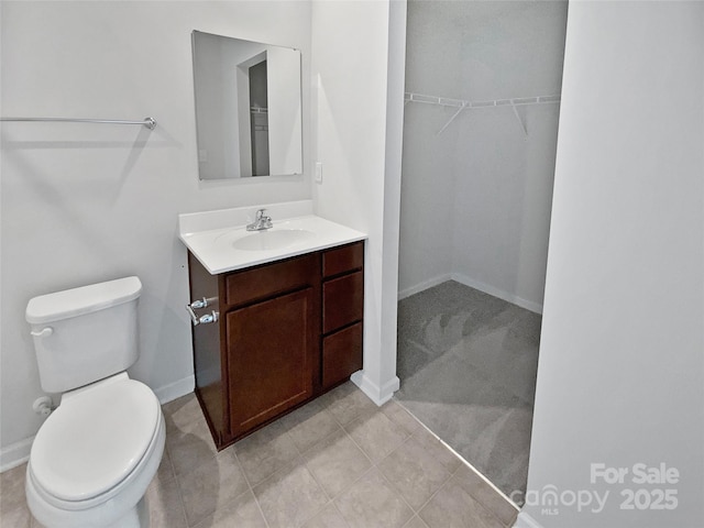 bathroom featuring vanity, tile patterned floors, and toilet