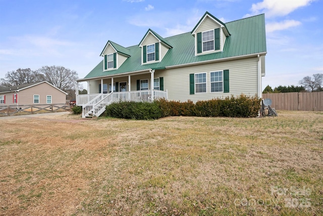 cape cod home with a front yard and a porch