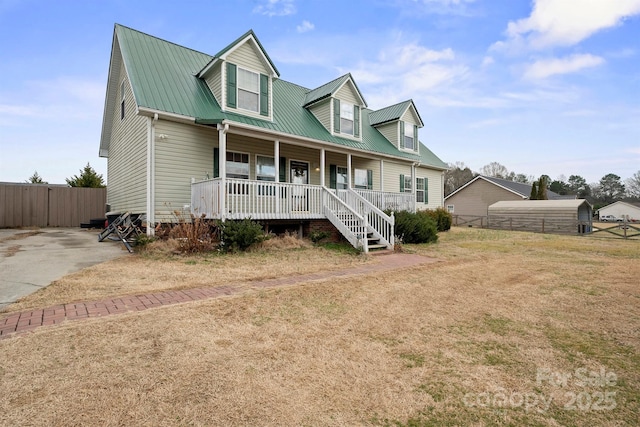 cape cod-style house featuring a front lawn and covered porch