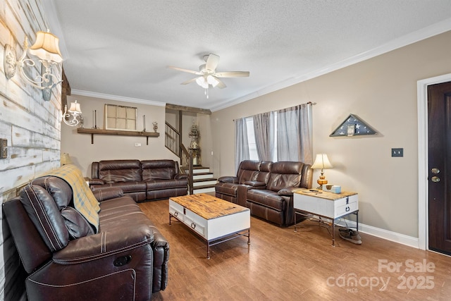 living room with hardwood / wood-style flooring, crown molding, ceiling fan, and a textured ceiling