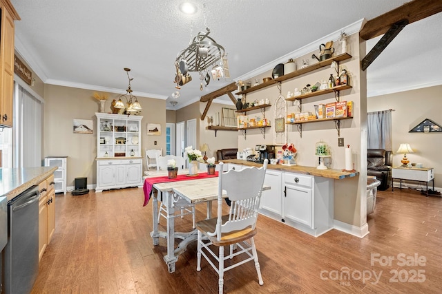 kitchen with white cabinetry, light hardwood / wood-style floors, stainless steel dishwasher, and a center island