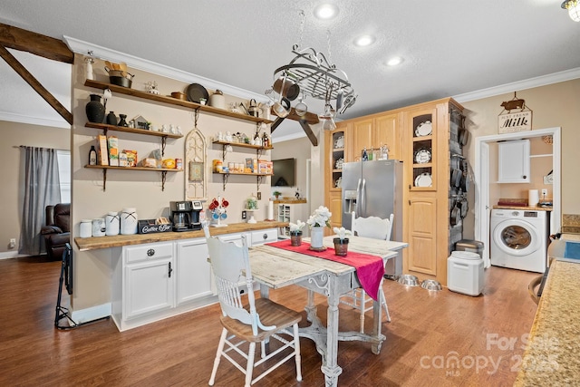 kitchen featuring stainless steel fridge, ornamental molding, washer / clothes dryer, and light wood-type flooring