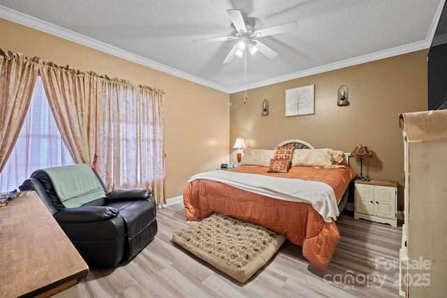 bedroom with ornamental molding, hardwood / wood-style floors, ceiling fan, and a textured ceiling