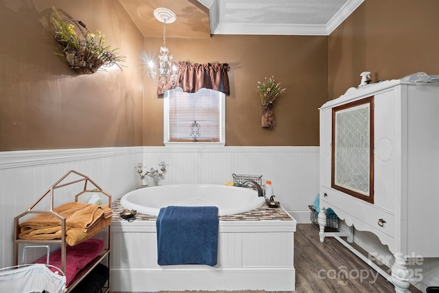 bathroom with wood-type flooring, a washtub, breakfast area, crown molding, and an inviting chandelier