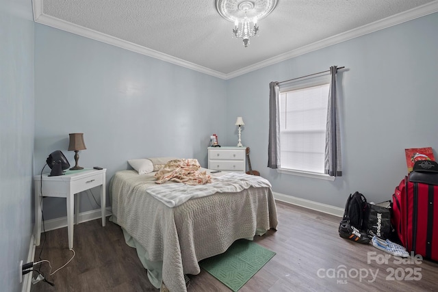 bedroom with wood-type flooring, ornamental molding, and a textured ceiling