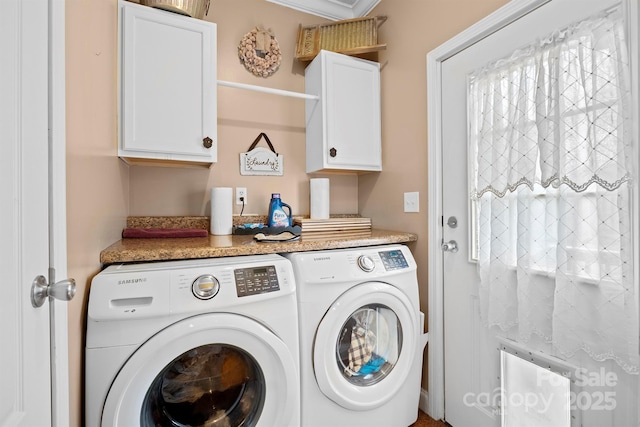 laundry area with cabinets and washer and clothes dryer