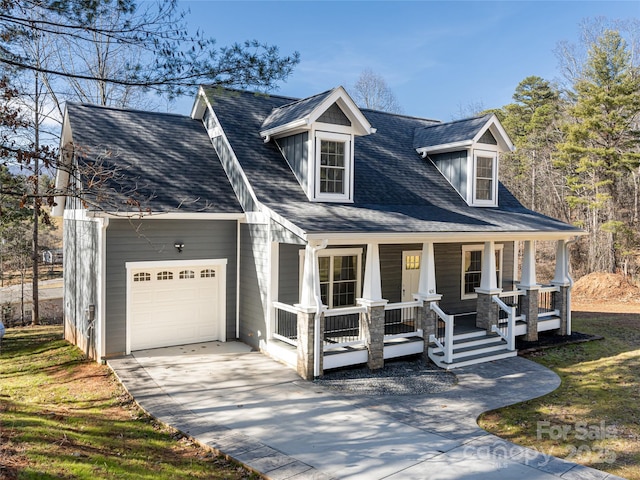 cape cod home with a garage and a porch