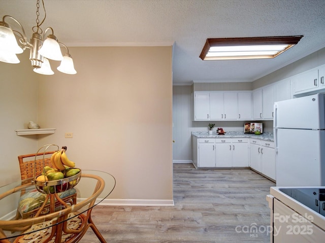 kitchen with white cabinetry, white appliances, ornamental molding, and decorative light fixtures