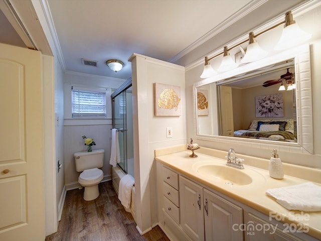 full bathroom with hardwood / wood-style flooring, crown molding, vanity, and toilet