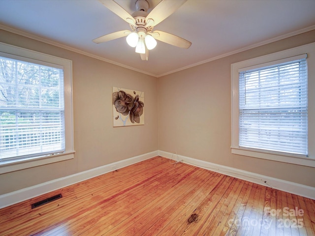 unfurnished room with crown molding, hardwood / wood-style floors, and ceiling fan