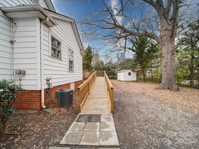 view of yard with cooling unit and a shed