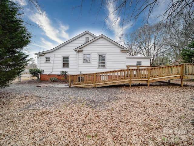 rear view of property with a wooden deck