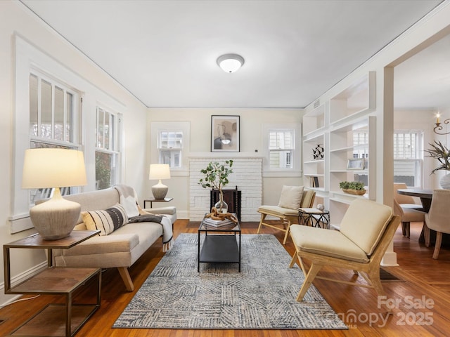 sitting room featuring a chandelier, hardwood / wood-style floors, and a fireplace