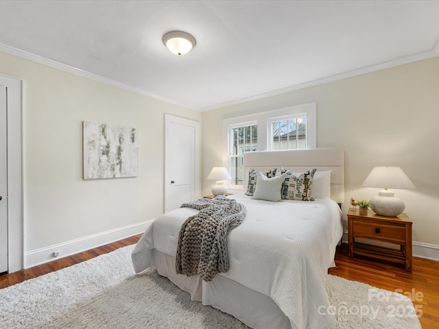 bedroom featuring ornamental molding and hardwood / wood-style floors