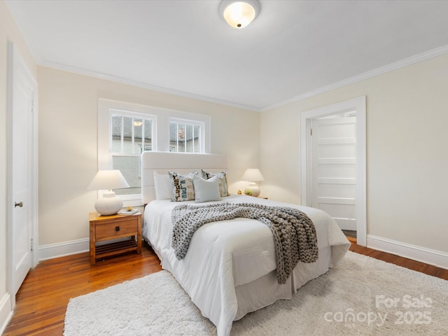 bedroom with crown molding and wood-type flooring