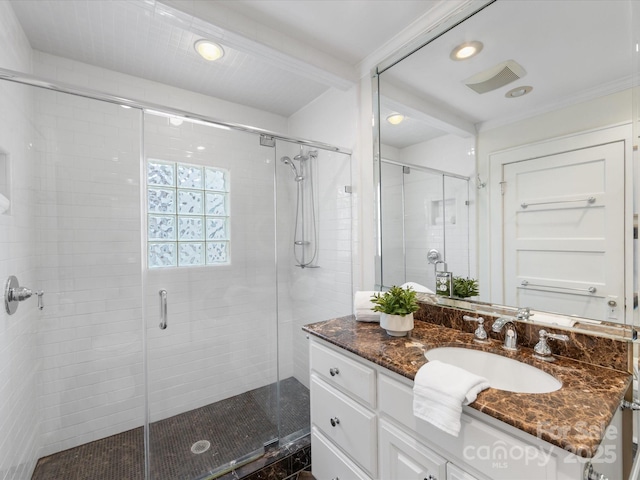 bathroom featuring vanity and an enclosed shower