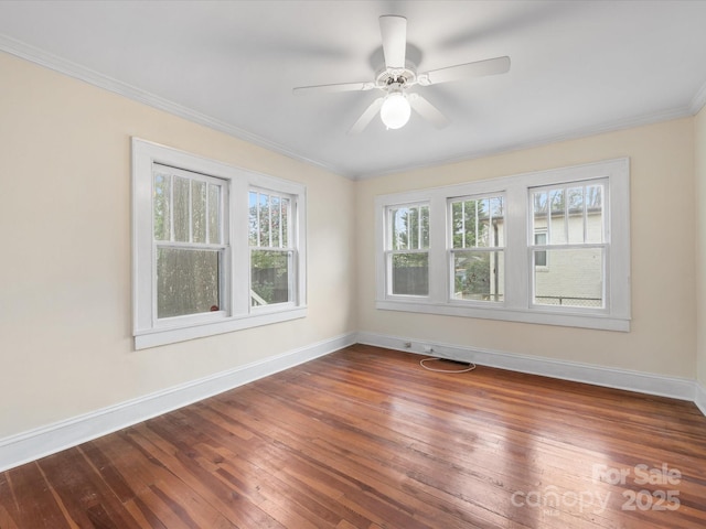 spare room with crown molding, dark hardwood / wood-style floors, and ceiling fan