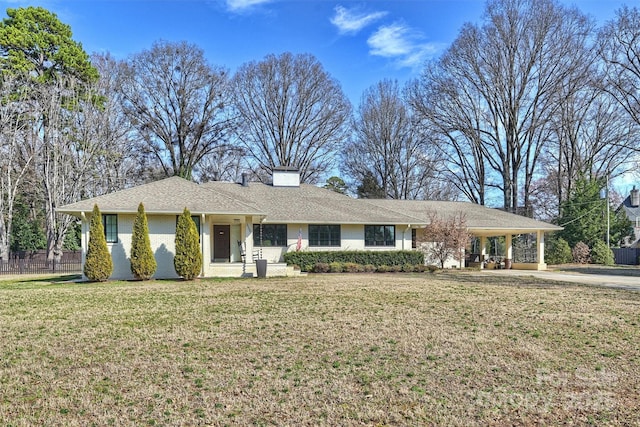 single story home featuring a front lawn and a carport