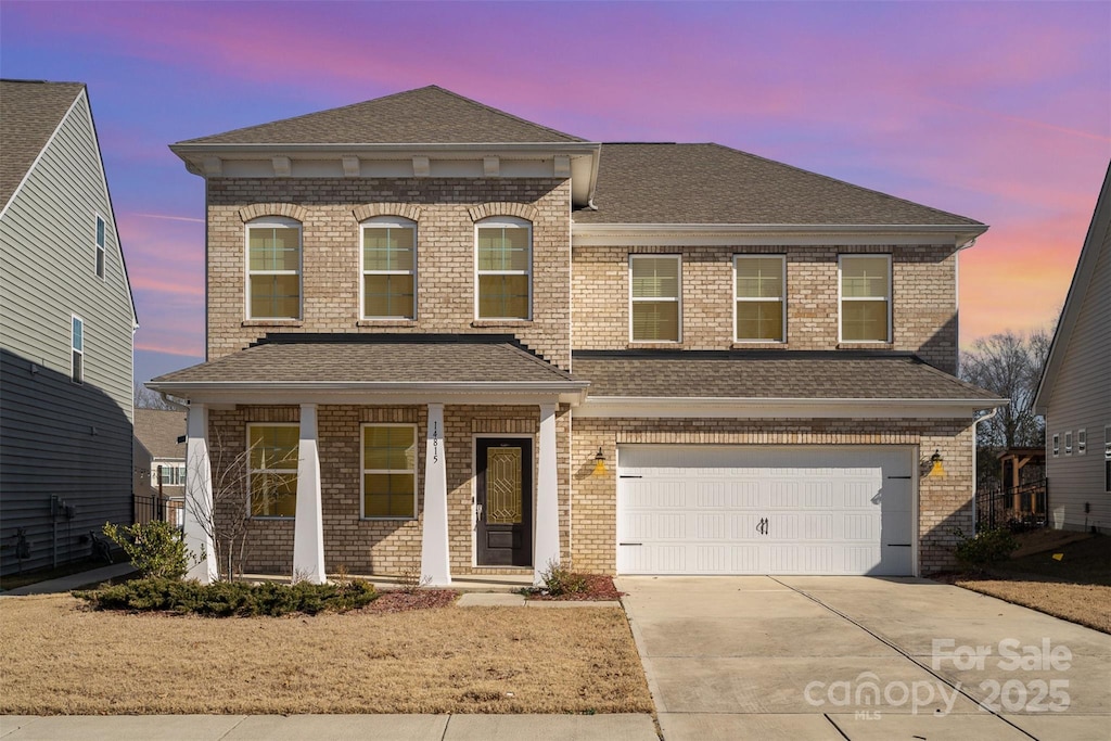 view of front of house featuring a garage and covered porch