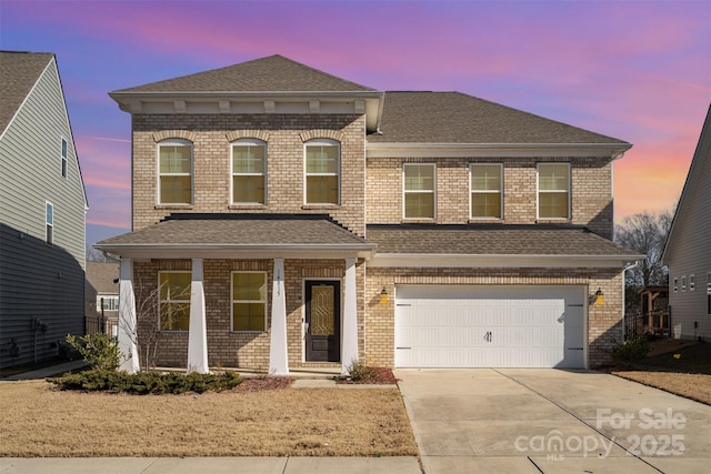 view of front of house featuring a garage and covered porch