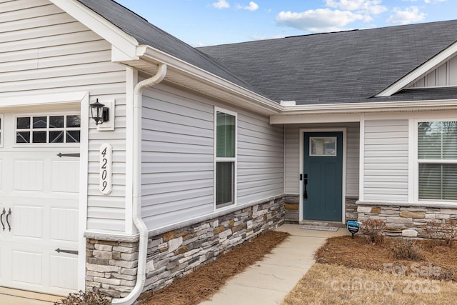 doorway to property featuring a garage