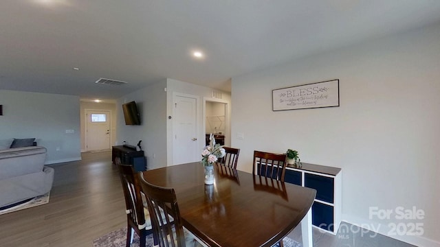 dining space with dark wood-type flooring