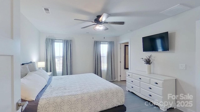 bedroom with ceiling fan and dark hardwood / wood-style flooring