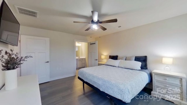 bedroom featuring ceiling fan, connected bathroom, and dark hardwood / wood-style floors