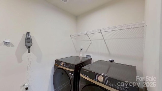 clothes washing area with washer and dryer