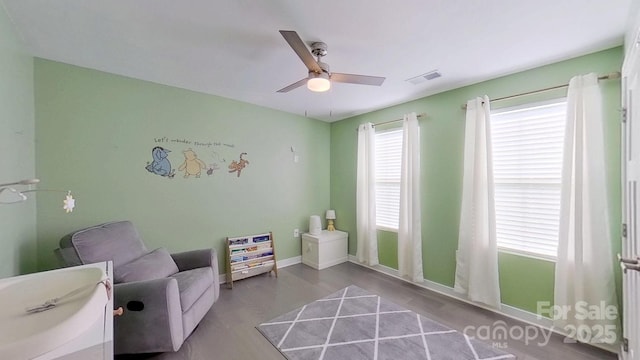 living area with light hardwood / wood-style floors and ceiling fan